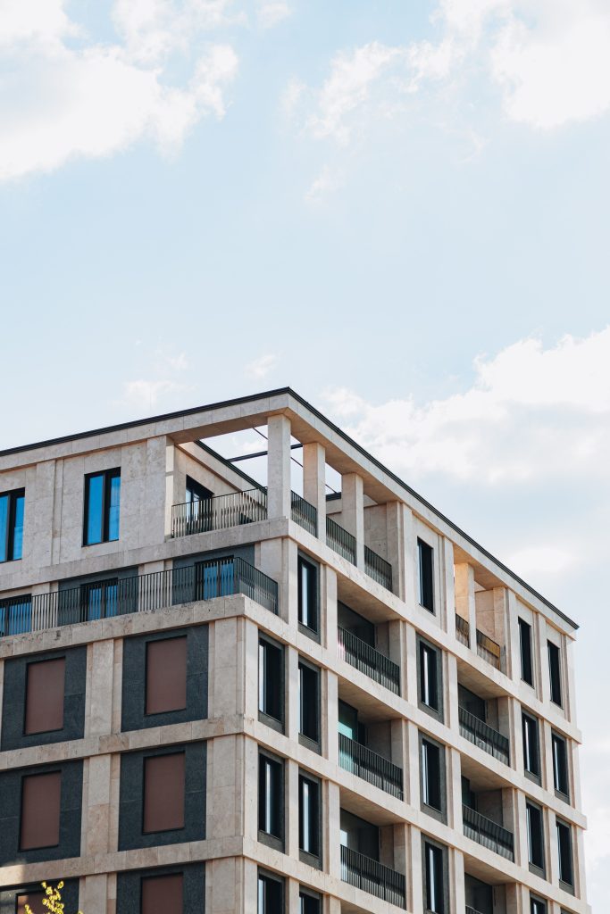 Stunning modern apartment building in Berlin showcasing contemporary architecture against a backdrop of a clear blue sky.